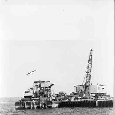 Crane and white building on right side with scaffolding on the other 1993