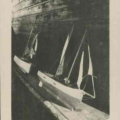 Two model sailboats on a bench 1919