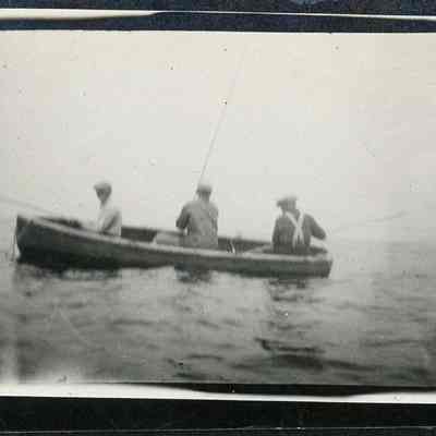 Three men fishing in rowboat 1924