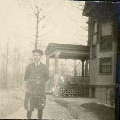 Young man standing outside of a house