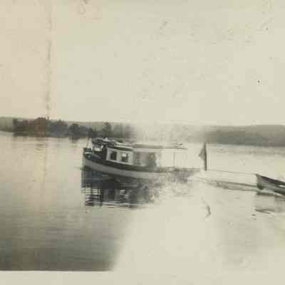 Launch towing a rowboat