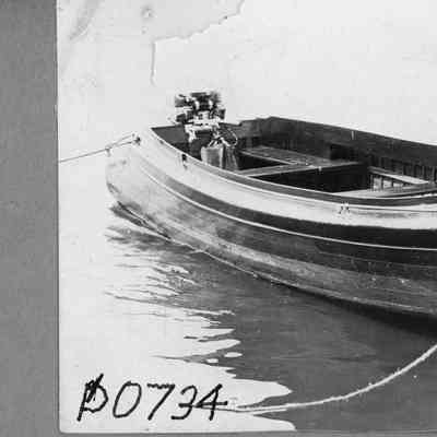 Runabout with outboard motor docked