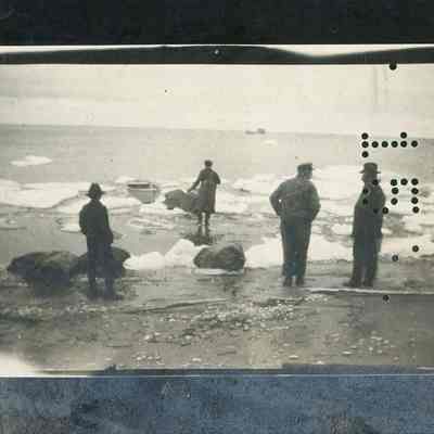 Men transferring mail to rowboat on Europe Bay