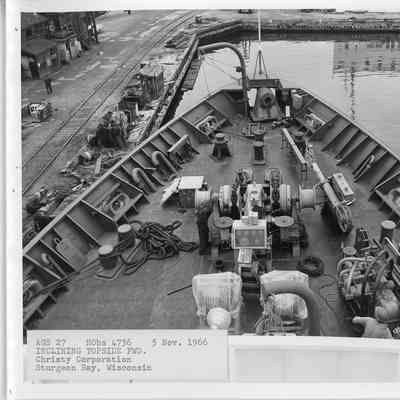 2 men checking machine in center 1966