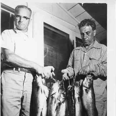 two men holding walleyes