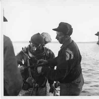 Man being equipped with diving suit