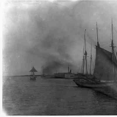 Masted sailing vessel in right foreground
