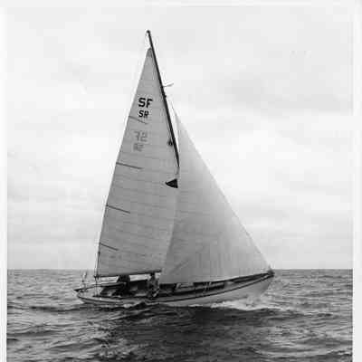 3 men in sailboat with letters SFSR on sails