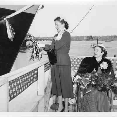 Joan McCarthy christening LST-1170 with Patricia VanRooy next to her May 22, 1954