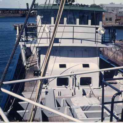 deck of boat with peach colored pole on the right side