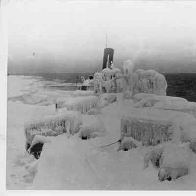 Ice covered vehicle and vessel in open water