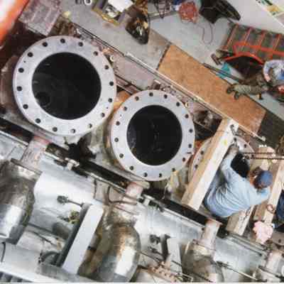 Aerial view of men working on engine of Medusa Challenger January 1998