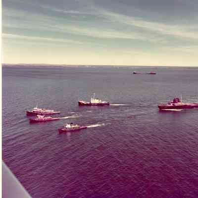 Cleveland Cliffs being towed by Selvick tug and two Roen Tugs