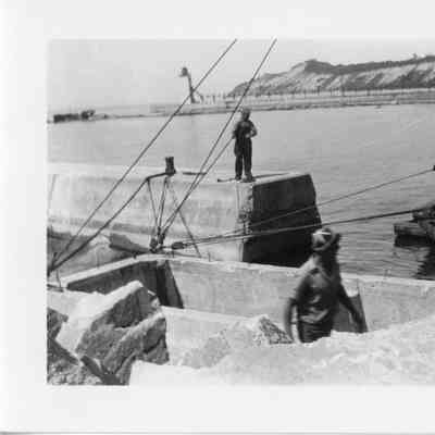 Men pulling rope on stone barge