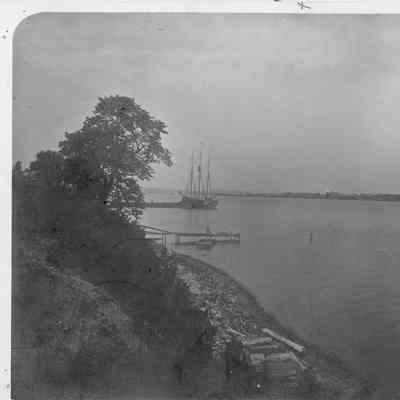 Three masted vessel at pier left shoreline