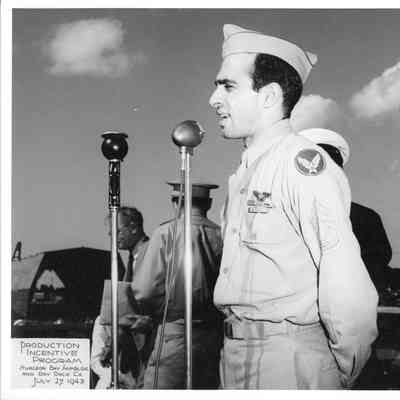 Man with microphone at SBSB&DD Co. production incentive program July 27, 1943