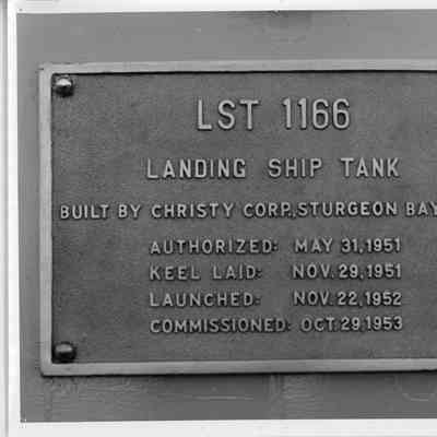 Metal plate with dates relating to LST-1166