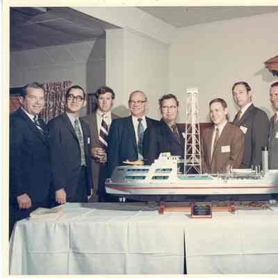 Group of people posing behind Alcoa Seaprobe model