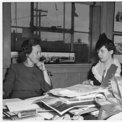 Alva Smith and sponsor sitting at table