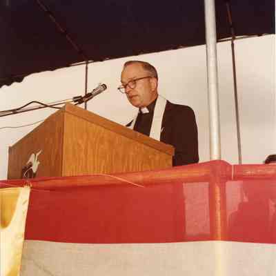 Priest at podium during christening of Napolean