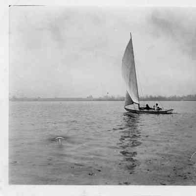 Two people sailing sailboat