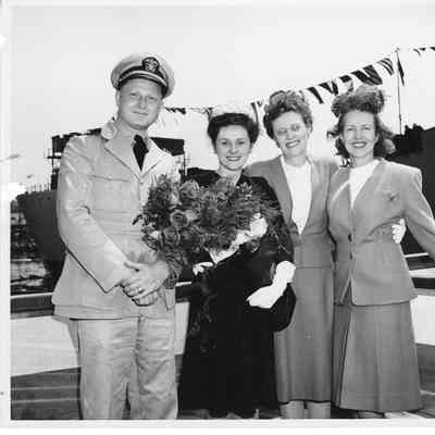 Mrs. Robert Rote Jr. and Sr. and Alva Smith at christening of AK-205 USS Poinsett