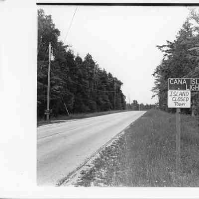 Road sign for directions to Cana Island Lighthouse stating "Island Closed Today" 1996