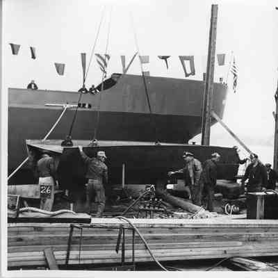 Crane lifting vessel section at Leathem D. Smith Shipbuilding Co.