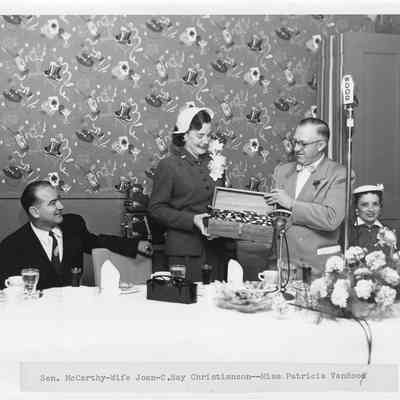 C. Ray Christianson giving christening case for LST-1170 to Joan McCarthy May 22, 1954