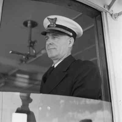 Officer at window of lighthouse tender Hollyhock