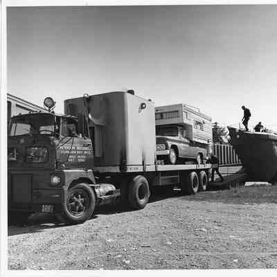 PBI truck loading truck and camper into US Army Larc LX49