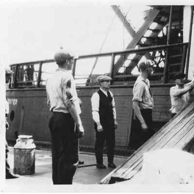 men unloading Frontier in drydock