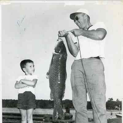 Man standing with large trout on line