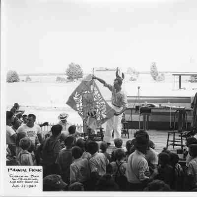 Man unfolding paper trick at SBSB&DD Co. 1st annual picnic August 22, 1943