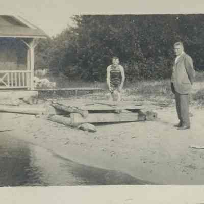 man in swimsuit building pier