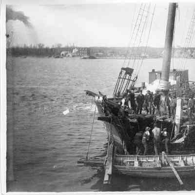 Loading posts on to ship at dock 1890