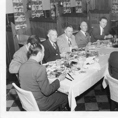 C. Ray Christianson eating dinner with group