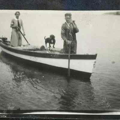Leni and Buddy hauling logs in skiff