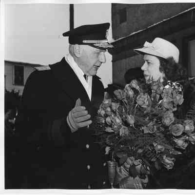 Rear Admiral William C. Watts talking to Miss Ann Duffy