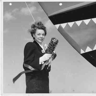 Mrs. W. DeFaut holding christening bottle at christening of F-568 April 12, 1944