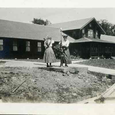 Two women operate pump at Cabot Lodge