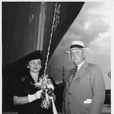 Mrs. John butterweck holding Champagne bottle containing milk