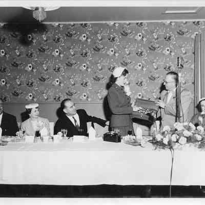 C. Ray Christianson giving Joan McCarthy LST-1170 sponsor case May 22, 1954