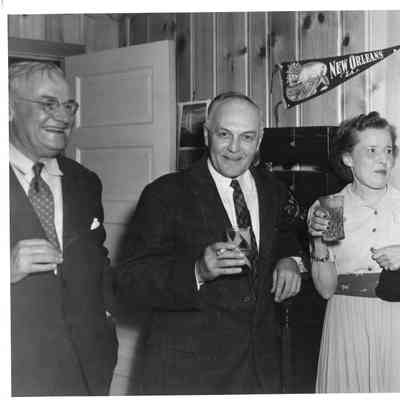Unidentified two men and one woman drinking