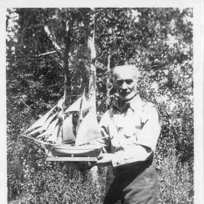 Guy McCracken holding ship model