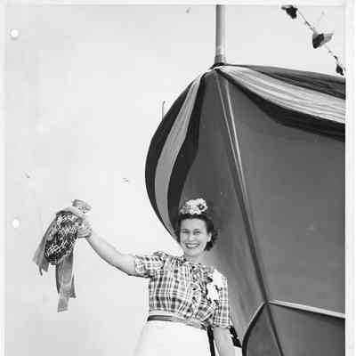 Ship sponsor holding christening bottle for P-573 post-christening September 11, 1944