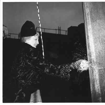 Mrs. Edward Frick hitting bottle of Champagne against Davenport