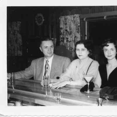 Four people at bar at Naval Christmas Party December 1952