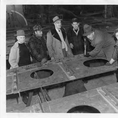 C. Ray Christianson using driving first rivet into the Spartan December 14, 1950