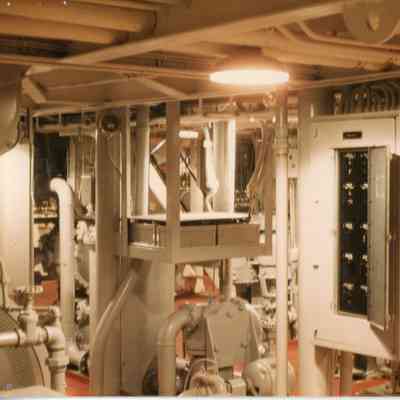Engine room of ship with 2 lights on